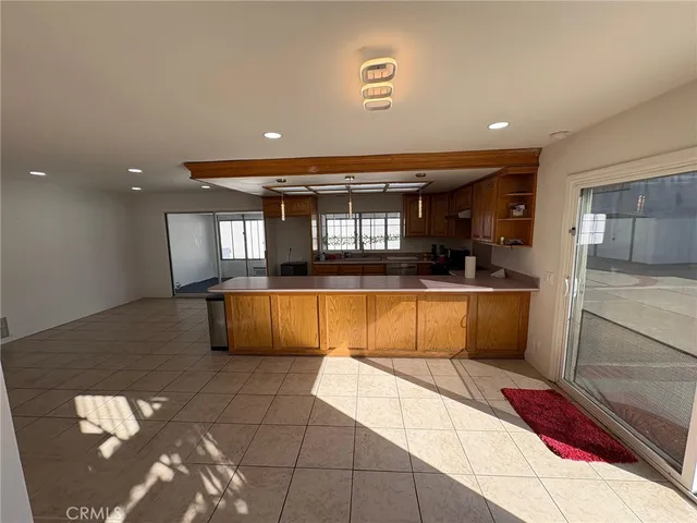 a large kitchen with kitchen island granite countertop a sink and a stove