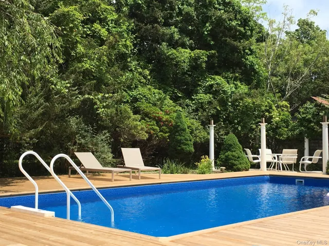 a view of swimming pool with seating area