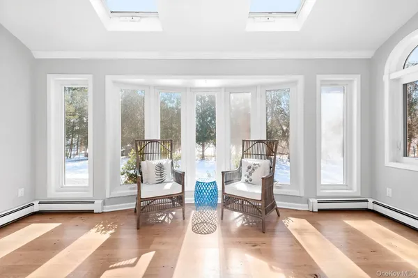 a living room with furniture and floor to ceiling windows