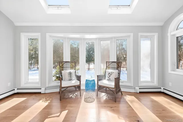 a living room with furniture and floor to ceiling windows