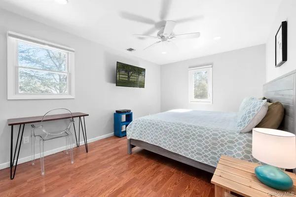 a bedroom with a bed window and a table