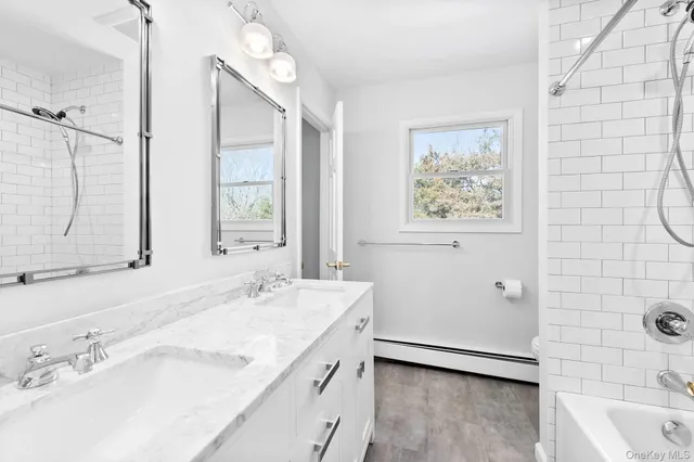 a bathroom with a granite countertop sink a large mirror and a shower