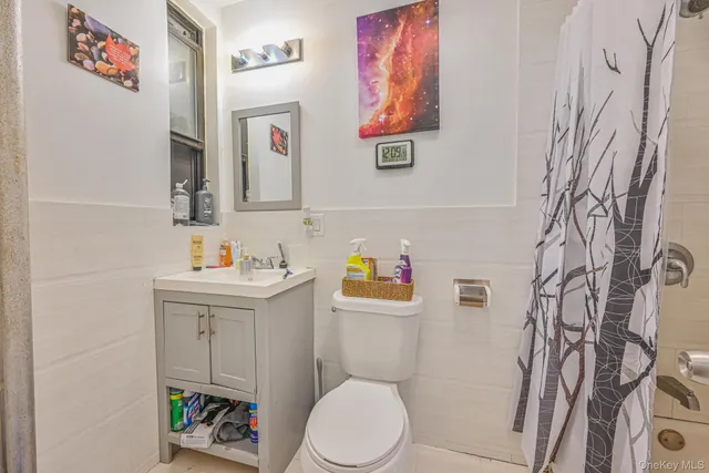a white toilet sitting next to a bathroom sink