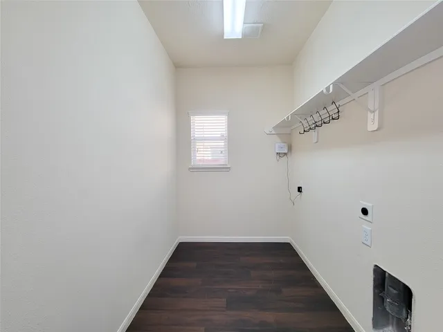 a kitchen with stainless steel appliances granite countertop a sink stove and white cabinets with wooden floor