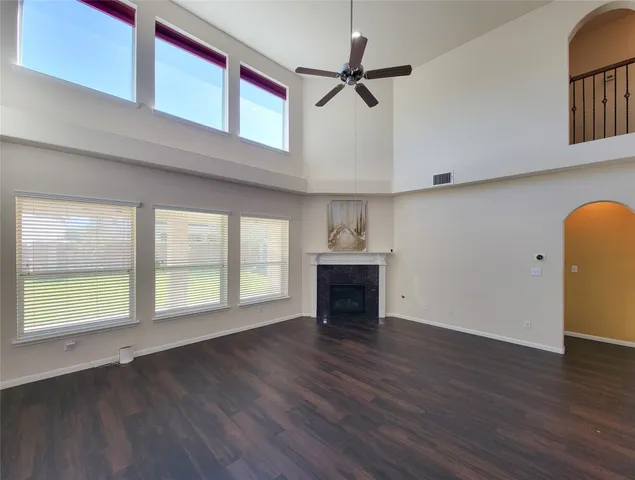 a large kitchen with cabinets wooden floor and stainless steel appliances