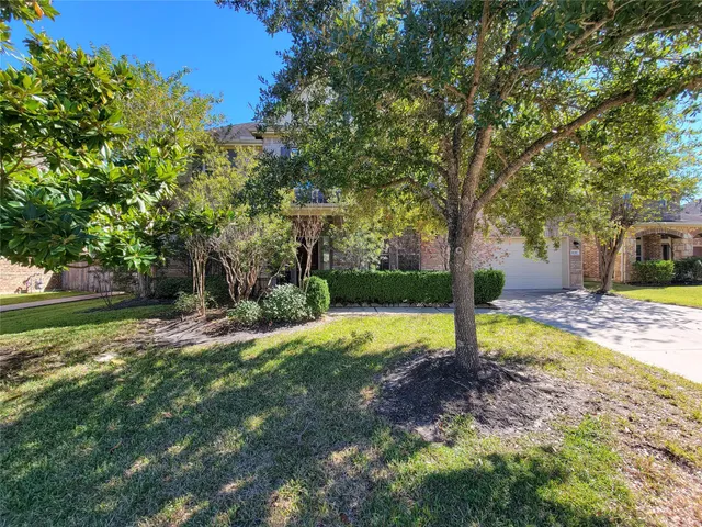 a view of a livingroom with wooden floor windows and a chandelier