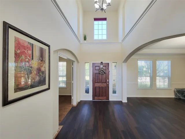 a view of entryway and hall with wooden floor