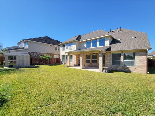 a front view of a house with a garden and yard
