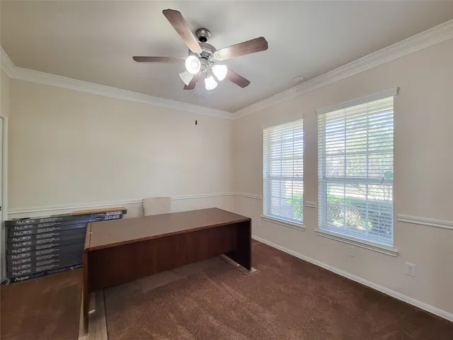a view of a livingroom with wooden floor and a ceiling fan