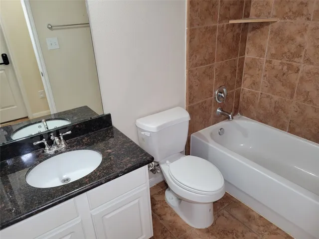 a kitchen with stainless steel appliances kitchen island wooden floors and white cabinets