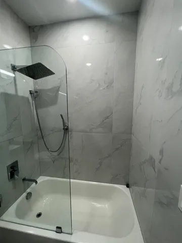 a bathroom with a shower and bathtub