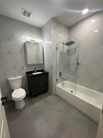 a bathroom with a toilet a sink and bathtub