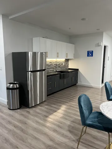 a kitchen with stainless steel appliances granite countertop a refrigerator and a stove top oven