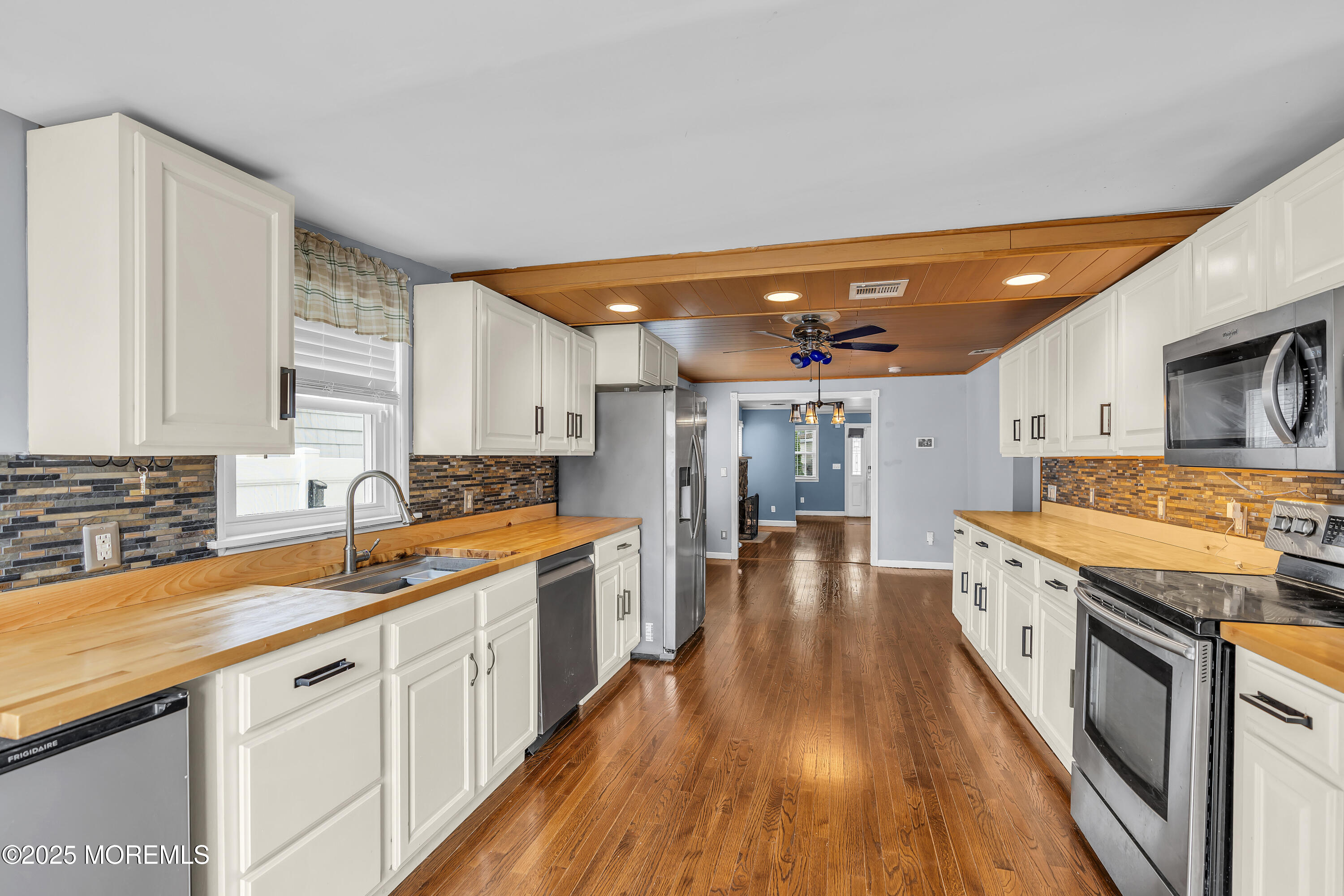 111 Breton Road Brick, NJ 08723 - Photo 14 of 59 a large kitchen with stainless steel appliances granite countertop a lot of counter space and wooden floors