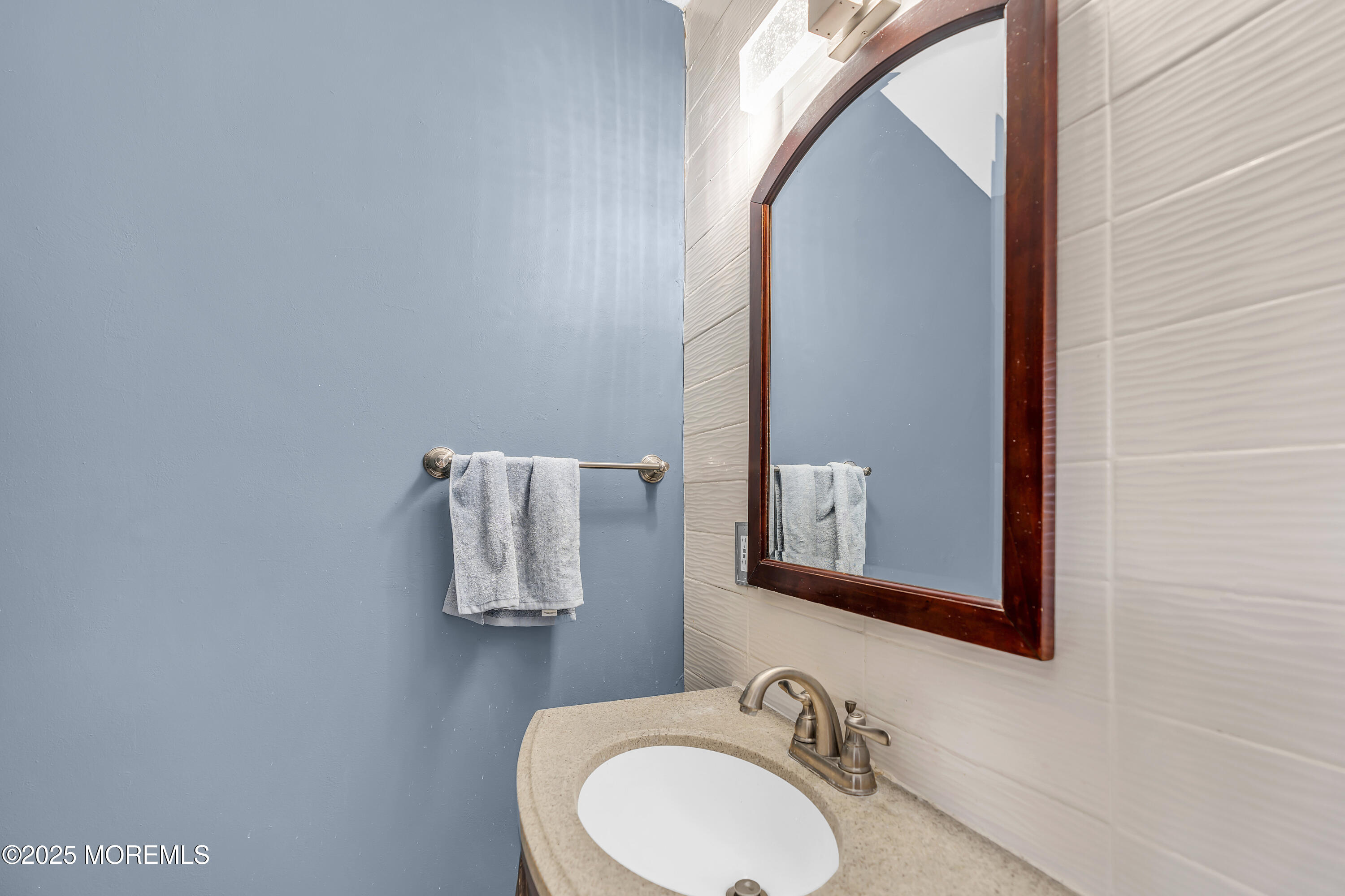 111 Breton Road Brick, NJ 08723 - Photo 25 of 59 a bathroom with a sink and a mirror