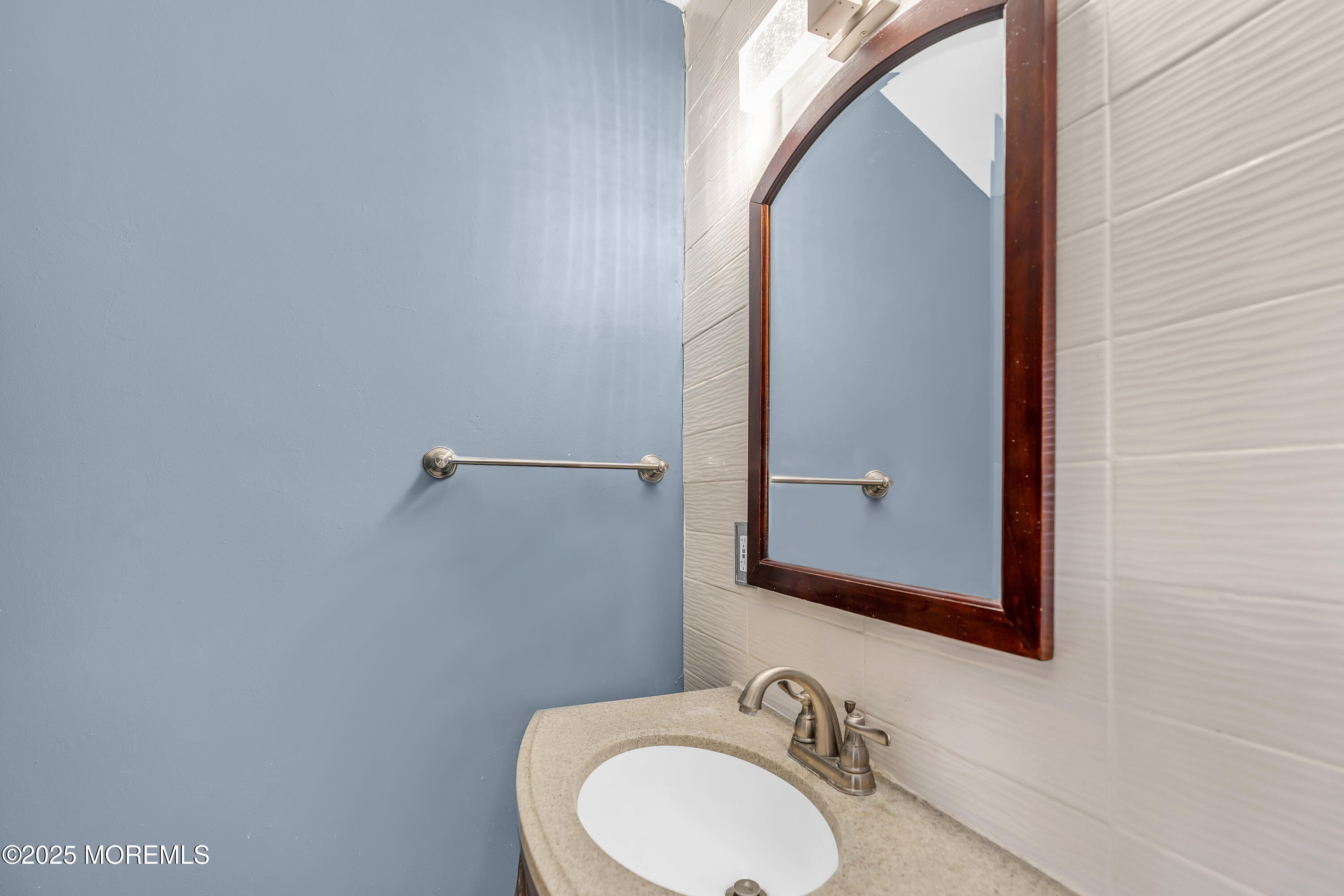 111 Breton Road Brick, NJ 08723 - Photo 45 of 59 a bathroom with a sink and a mirror