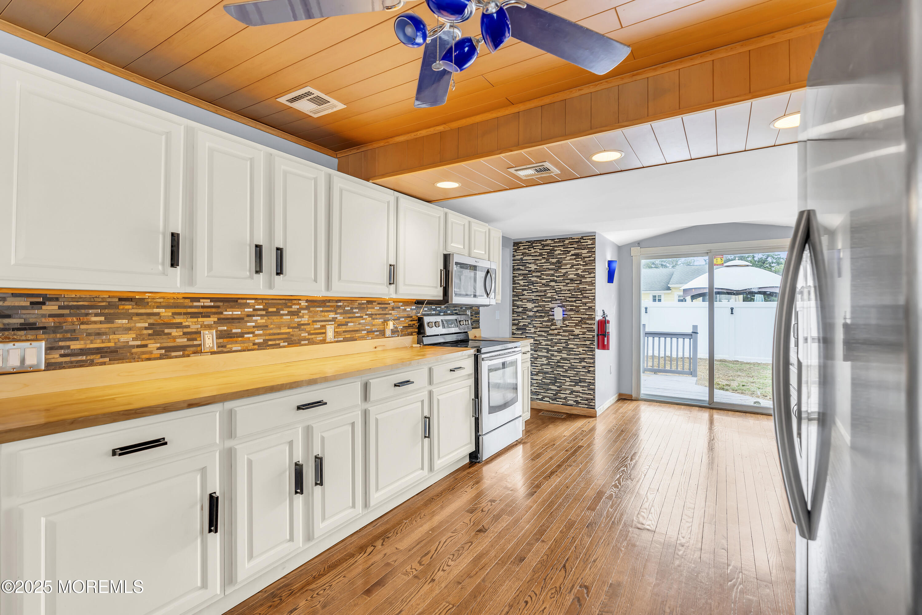 111 Breton Road Brick, NJ 08723 - Photo 10 of 59 a kitchen with granite countertop a refrigerator and wooden floor