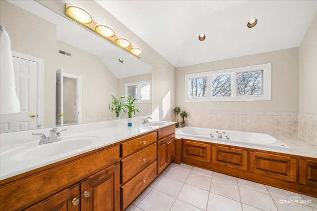 a spacious bathroom with a double vanity sink and a mirror
