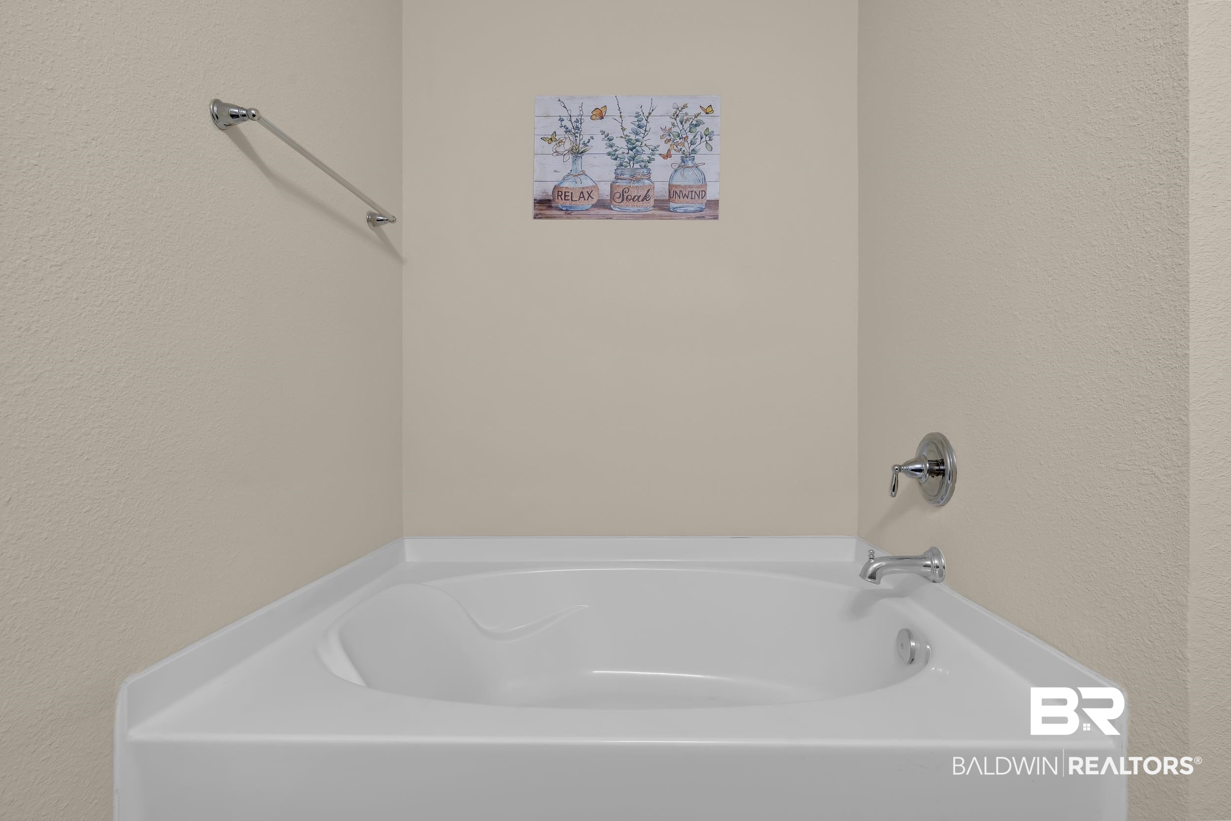 1704 Abbey Loop Foley, AL 36535 - Photo 21 of 38 Corner soaking tub with chrome fixtures and light-toned wall finish