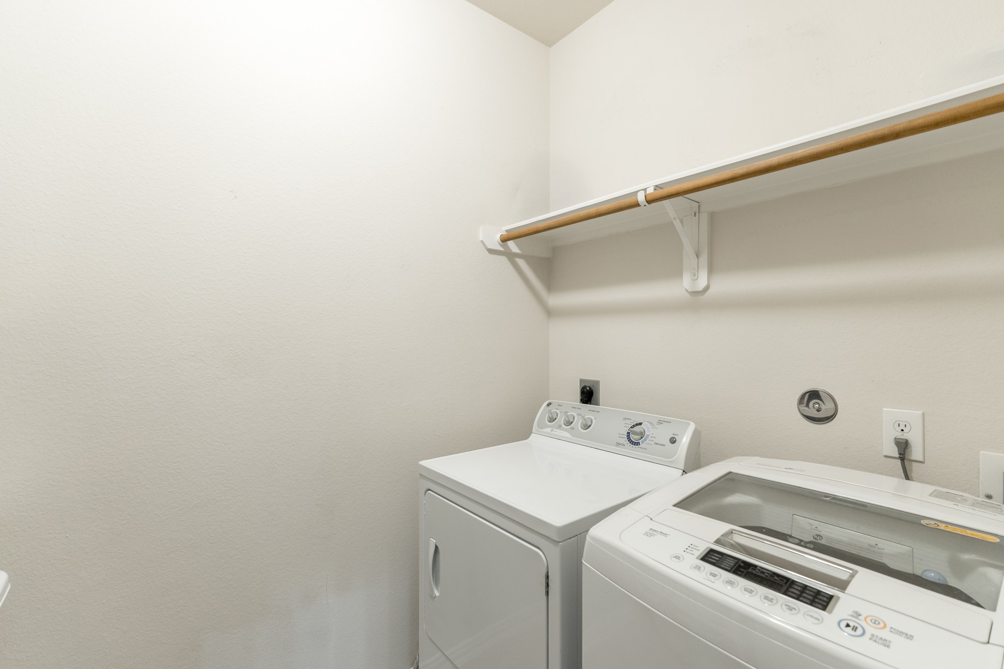 79 West Jagged Ridge Circle Spring, TX 77389 - Photo 40 of 50 The conveniently located laundry room offers space for a full-size washer and dryer along with overhead shelving for added storage and organization. This practical, well-placed space makes managing household chores simple and efficient.