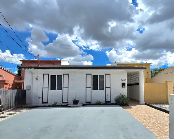 a view of a house with a yard and garage