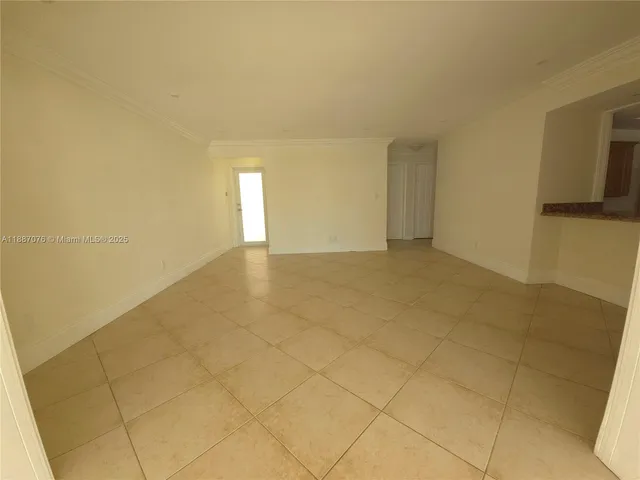 a view of an empty room and a window