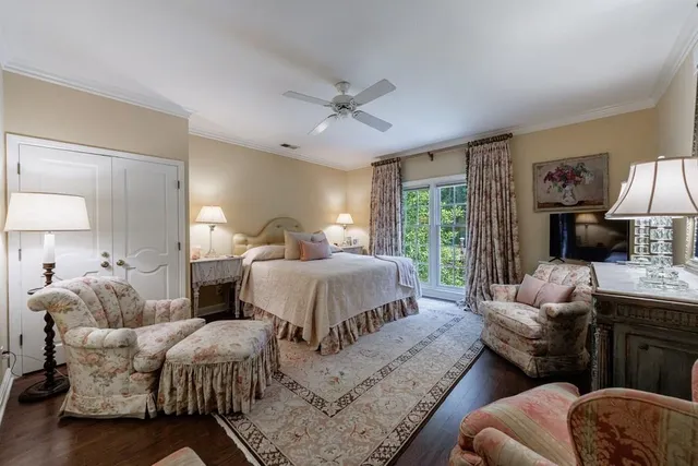 a bedroom with a bed couches chair and a fireplace