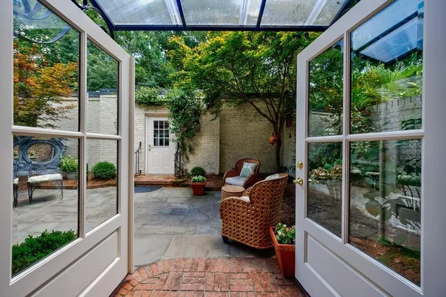 a view of a porch with furniture and garden