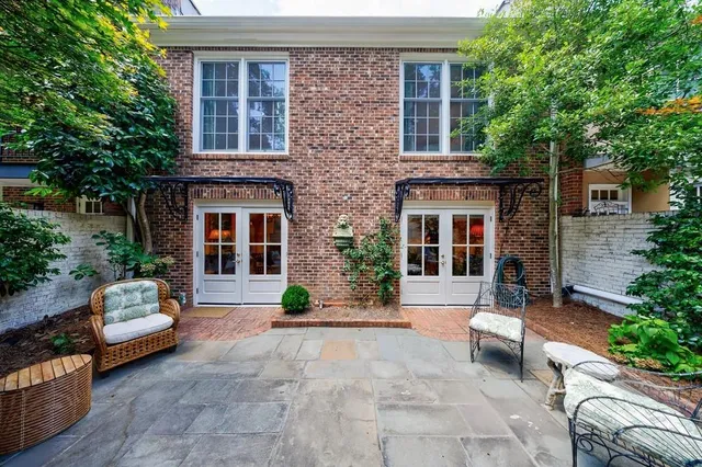 a view of a brick house with couches in front of a house