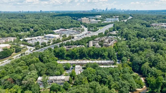 an aerial view of a house with yard and outdoor seating