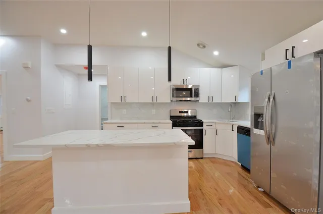 a kitchen with stainless steel appliances a refrigerator sink and stove
