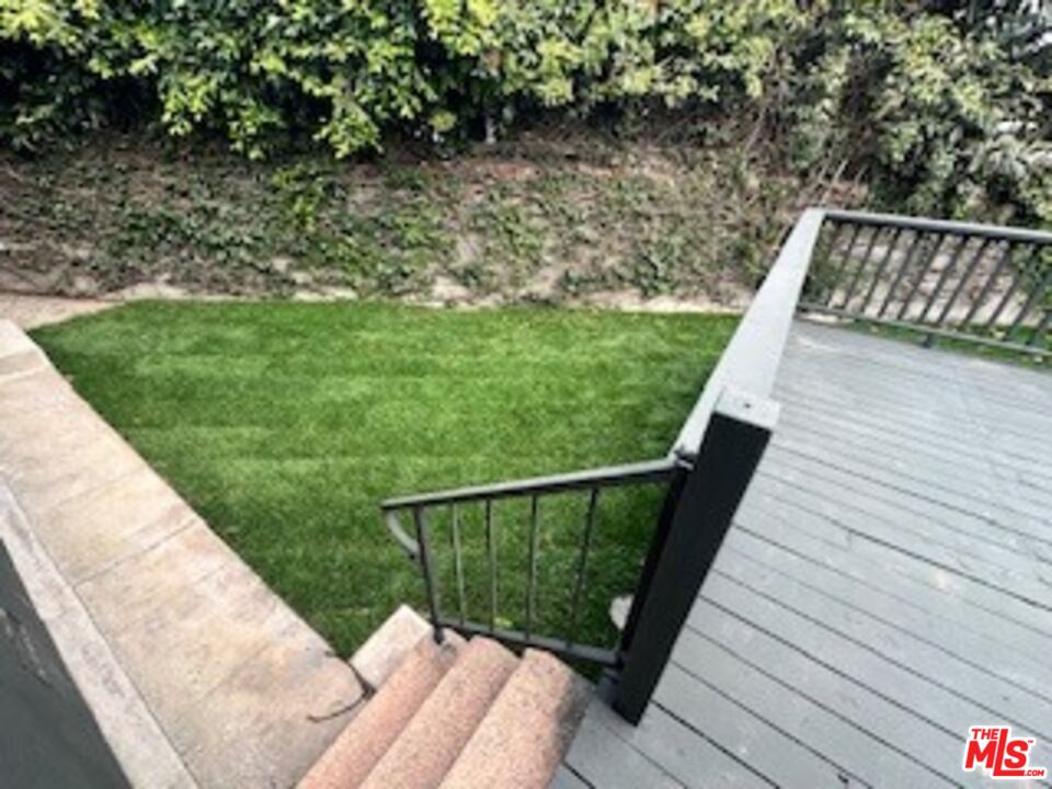 620 25th Street Manhattan Beach, CA 90266 - Photo 35 of 51 a balcony with wooden floor and yard in the back