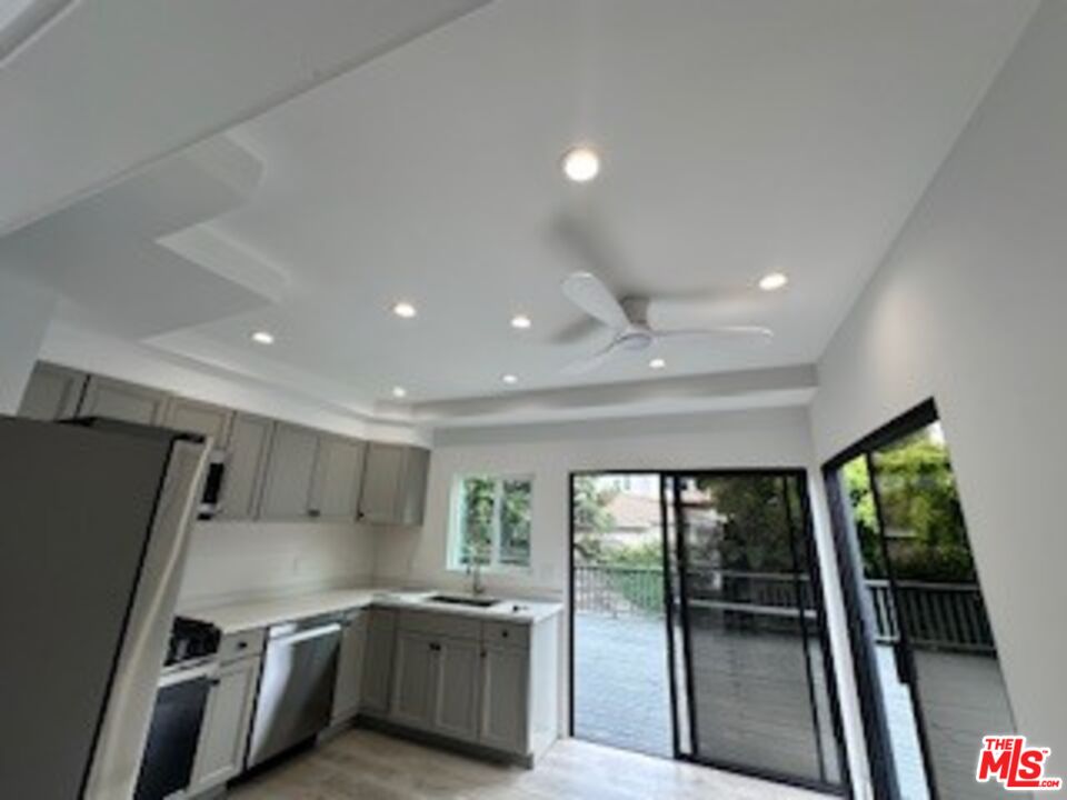 620 25th Street Manhattan Beach, CA 90266 - Photo 42 of 51 a kitchen with stainless steel appliances a refrigerator a sink a stove top oven a large window with a dining table and chairs