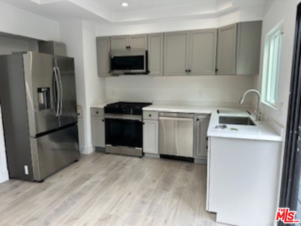 620 25th Street Manhattan Beach, CA 90266 - Photo 9 of 51 a kitchen with a sink stove and refrigerator