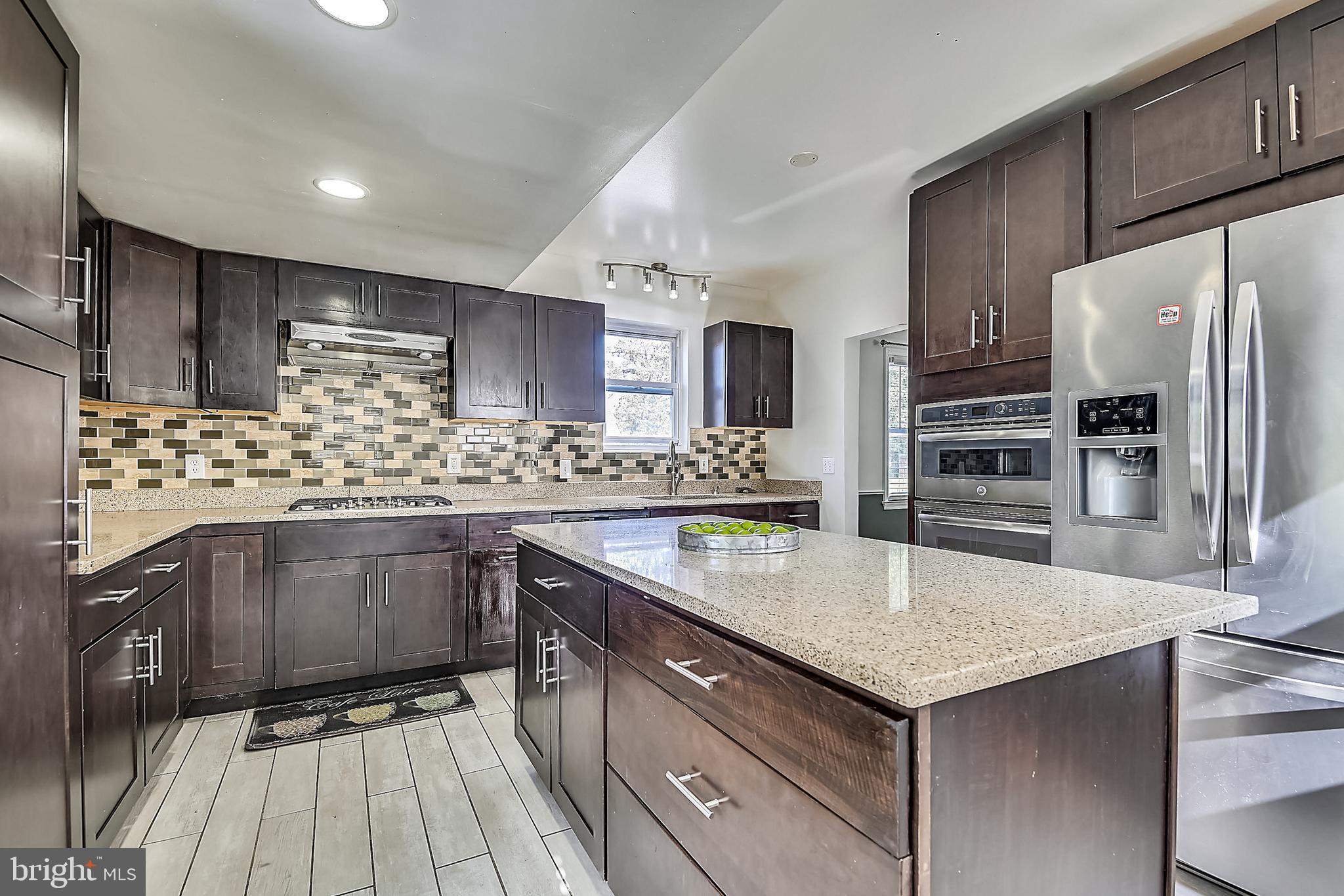 7420 Old Harford Road Baltimore, MD 21234 - Photo 22 of 35 Stainless appliances and glass tile backsplash