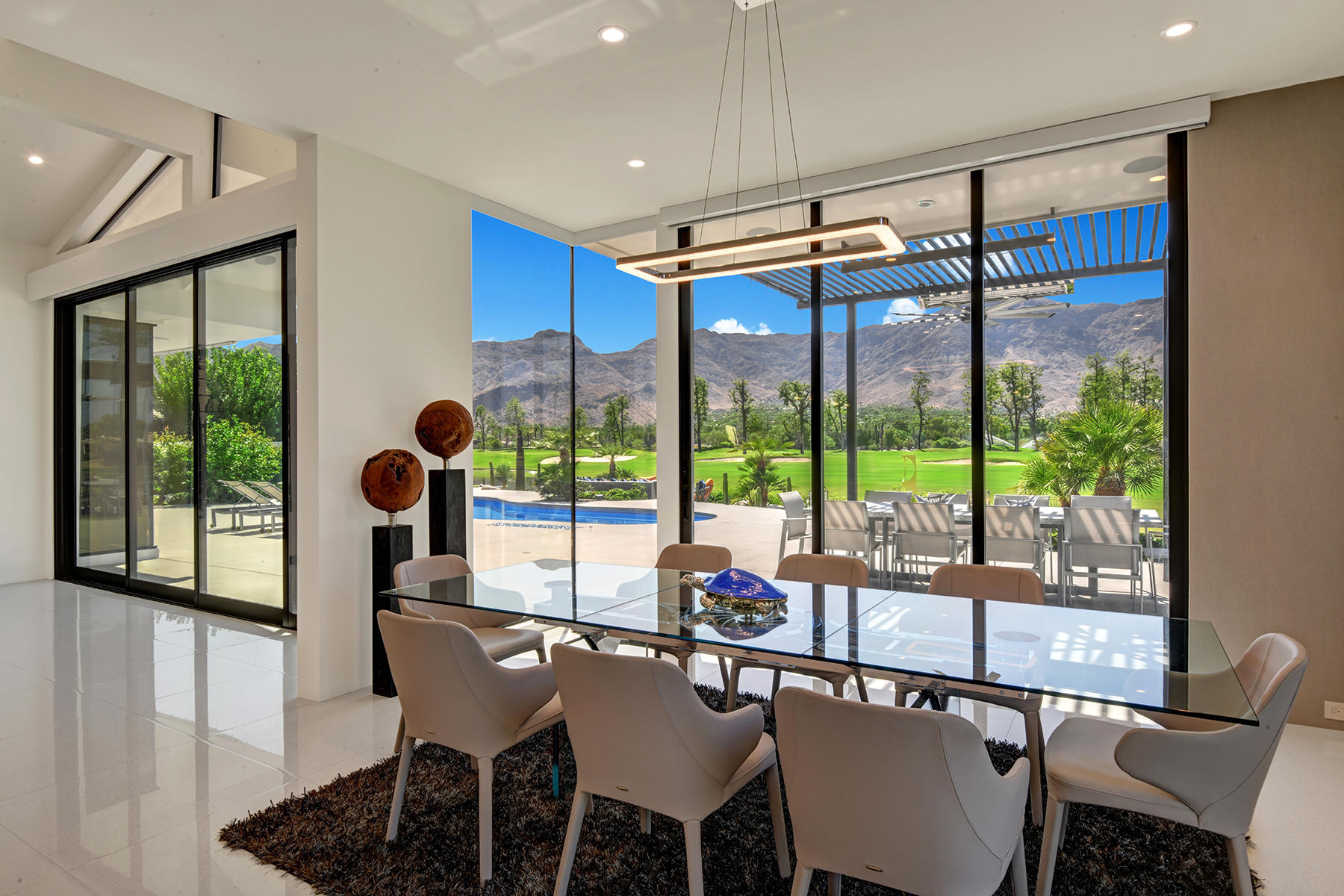 4 Deerfield Court Rancho Mirage, CA 92270 - Photo 14 of 53 a dining room with furniture a chandelier and wooden floor