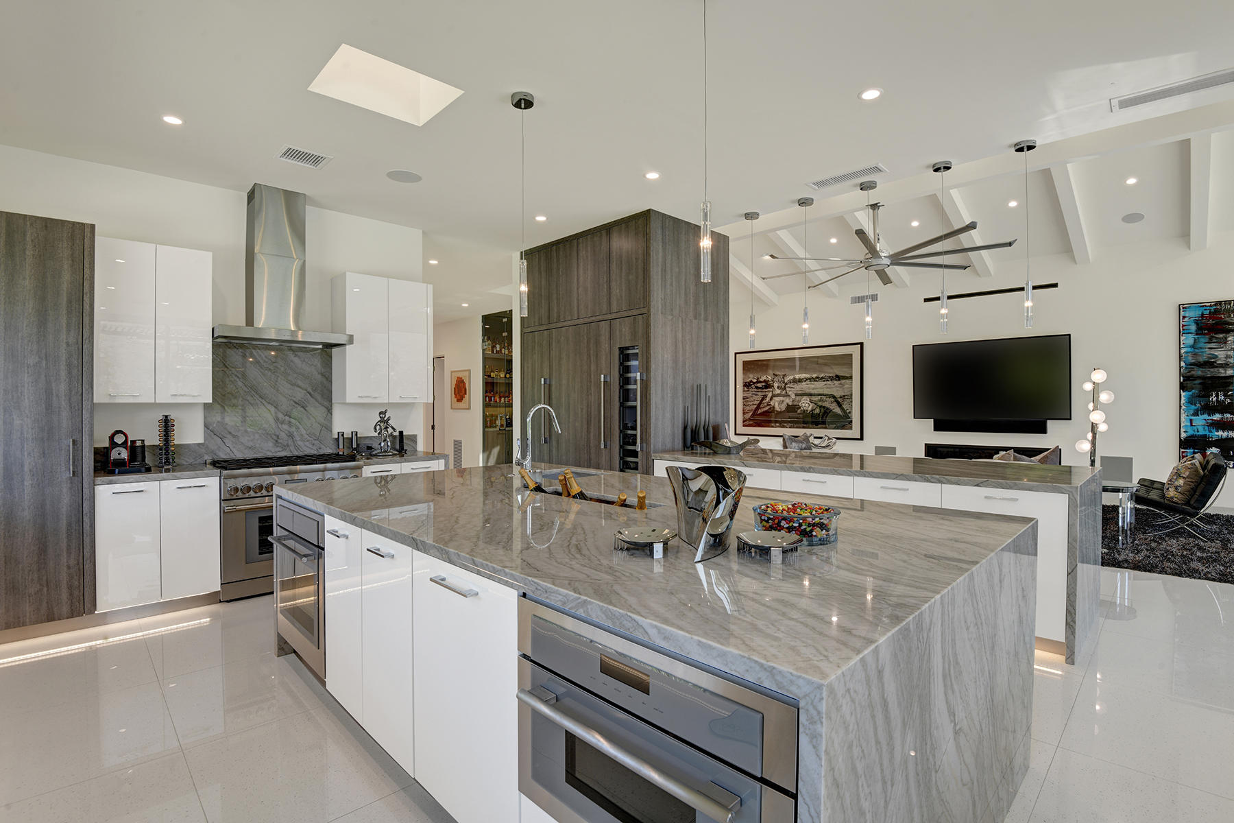 4 Deerfield Court Rancho Mirage, CA 92270 - Photo 18 of 53 a kitchen with stainless steel appliances kitchen island granite countertop a sink and a stove top oven with wooden floor