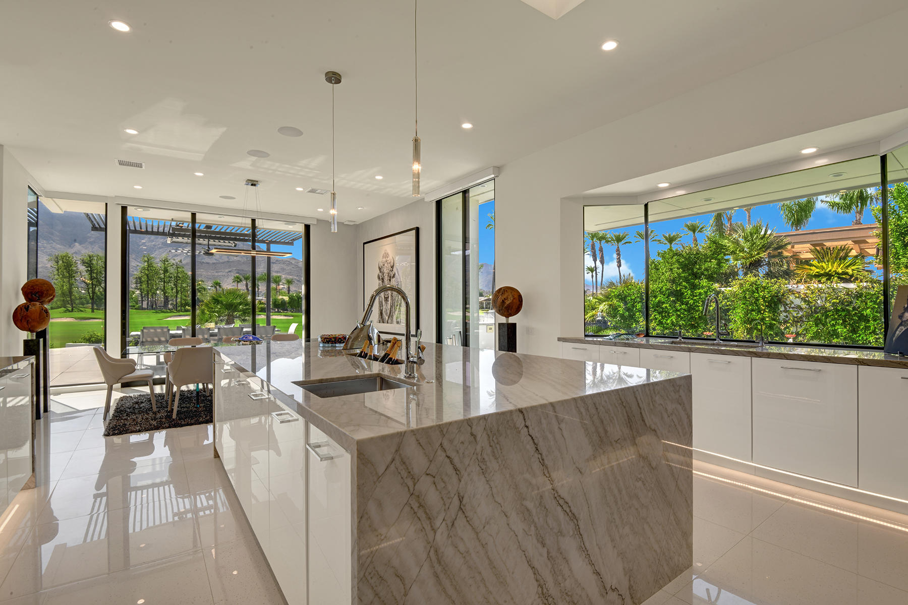 4 Deerfield Court Rancho Mirage, CA 92270 - Photo 19 of 53 a large kitchen with kitchen island a large window in it