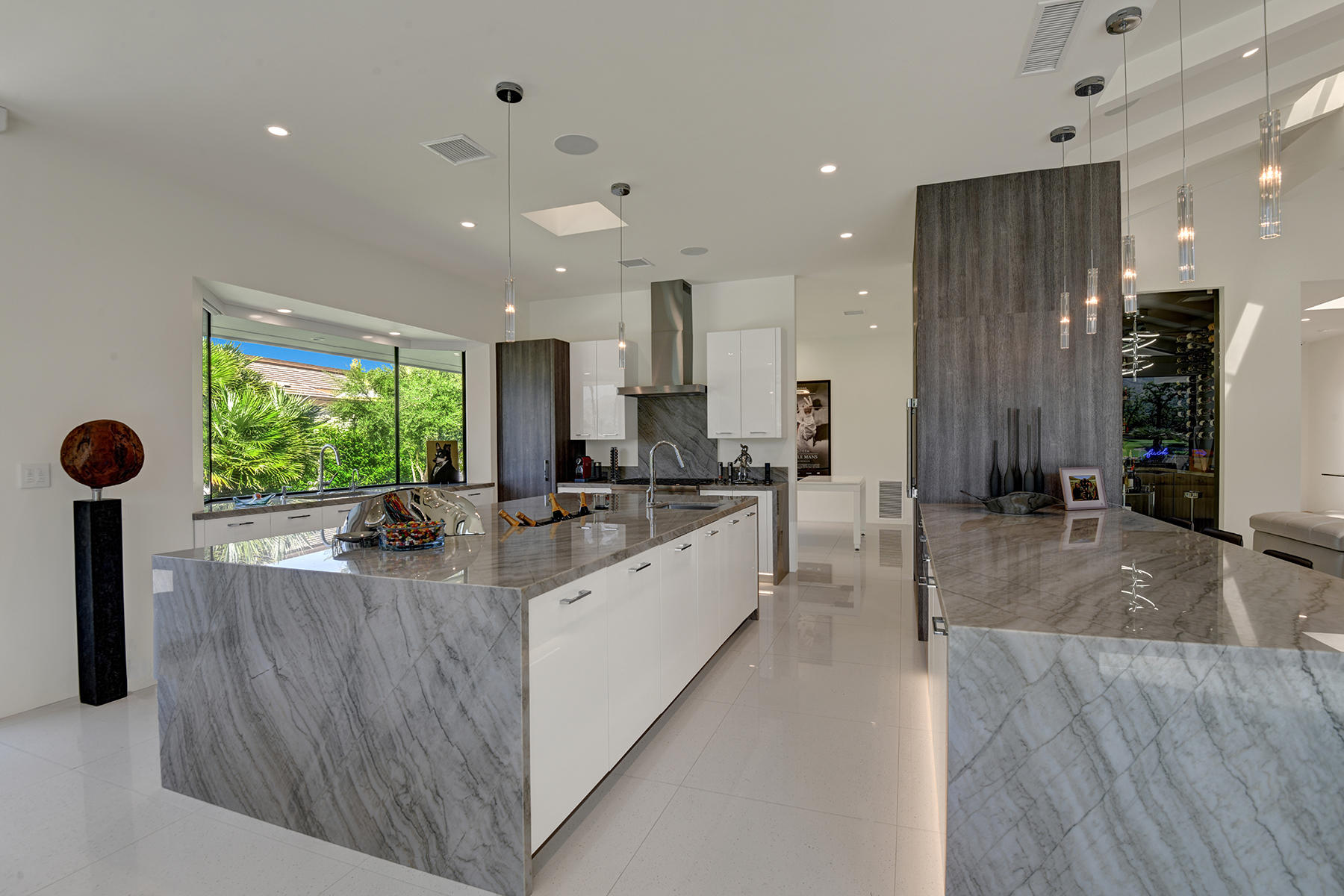 4 Deerfield Court Rancho Mirage, CA 92270 - Photo 20 of 53 a large room with kitchen island a large window a sink and stainless steel appliances