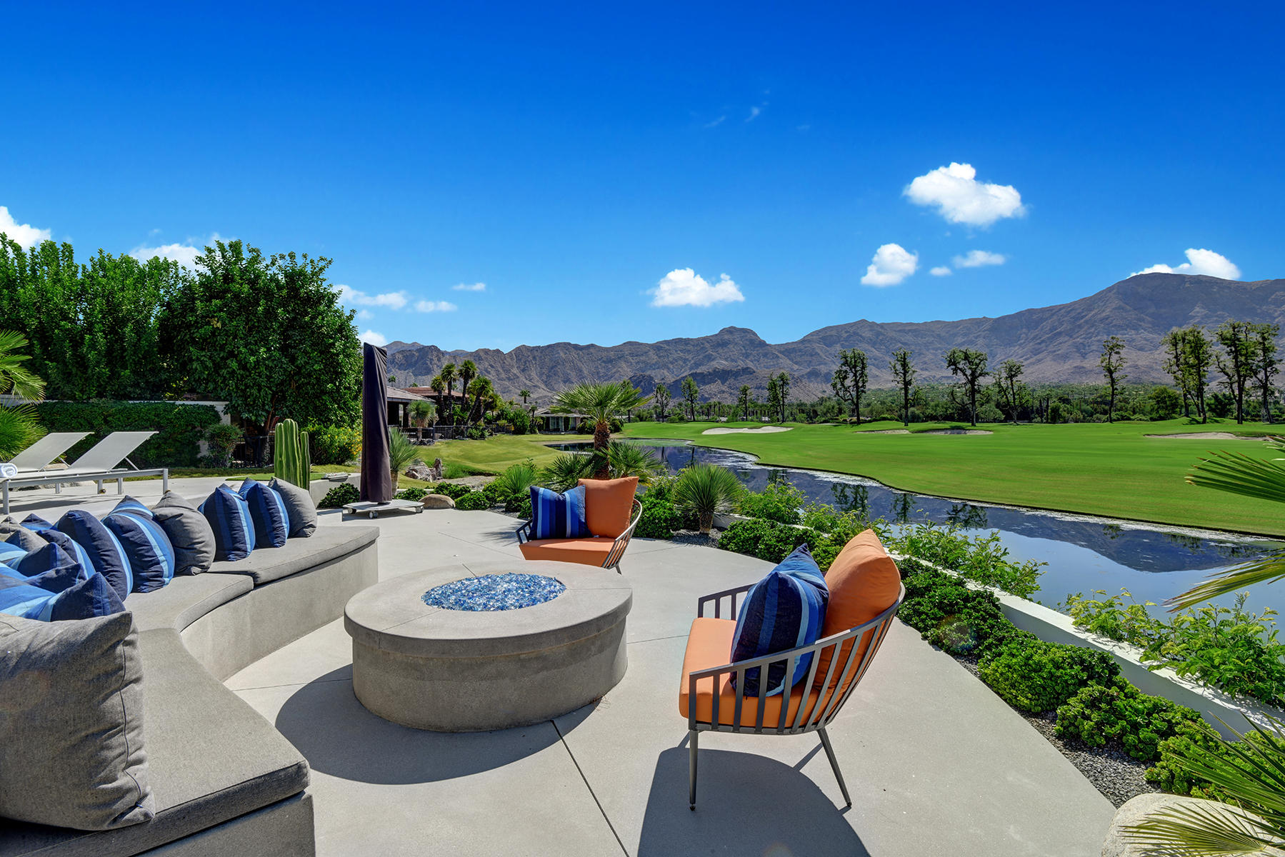4 Deerfield Court Rancho Mirage, CA 92270 - Photo 39 of 53 a view of a patio with couches and table and chairs and potted plants