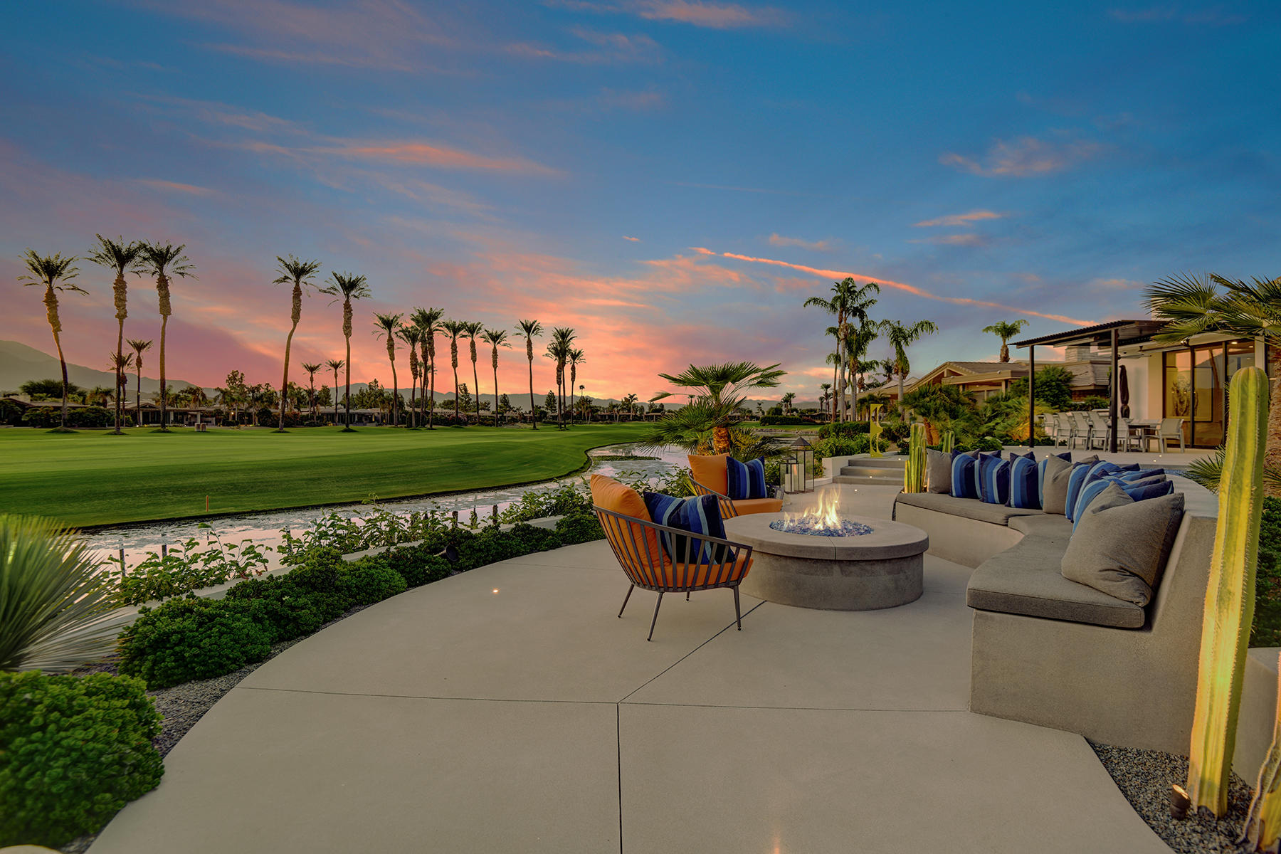 4 Deerfield Court Rancho Mirage, CA 92270 - Photo 43 of 53 a view of a patio with couches and a table and chairs with garden view