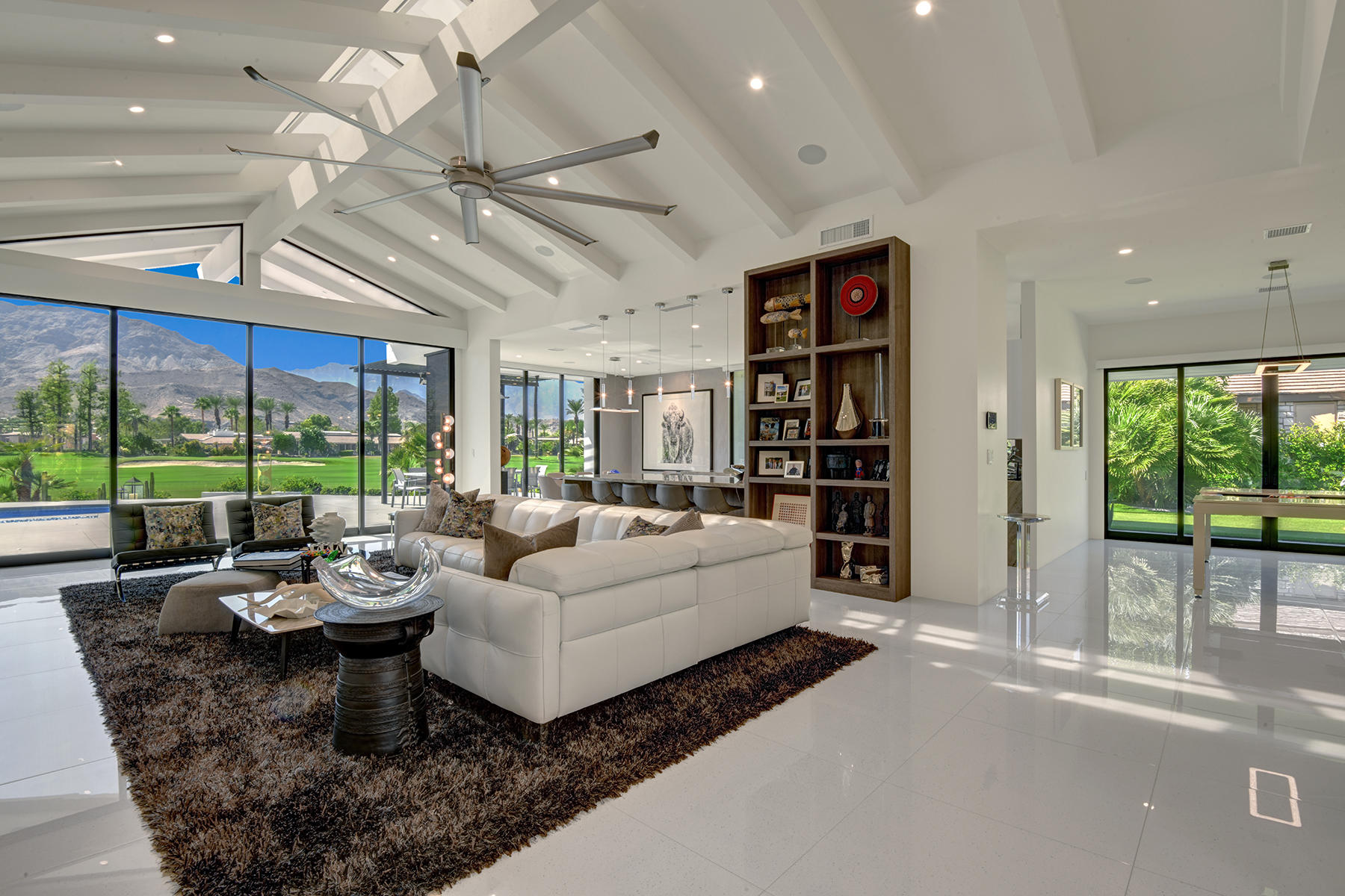 4 Deerfield Court Rancho Mirage, CA 92270 - Photo 9 of 53 a living room with furniture a floor to ceiling window and a flat screen tv