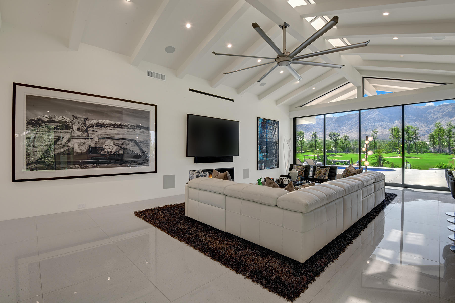 4 Deerfield Court Rancho Mirage, CA 92270 - Photo 10 of 53 a living room with furniture a flat screen tv and a large window