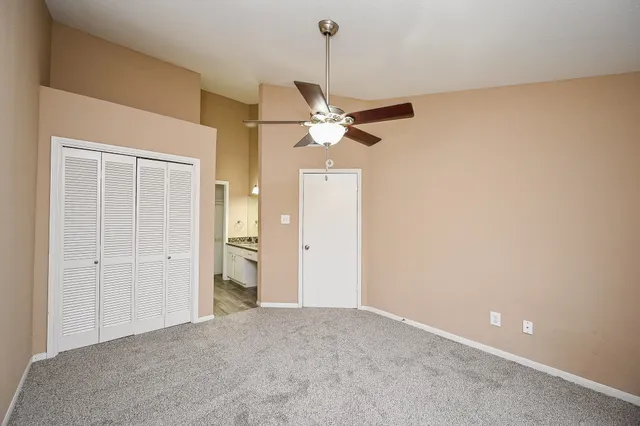 a view of a livingroom with a chandelier fan