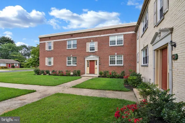 a view of a brick house with a yard