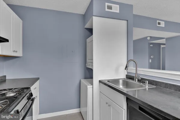 a kitchen with a sink and cabinets