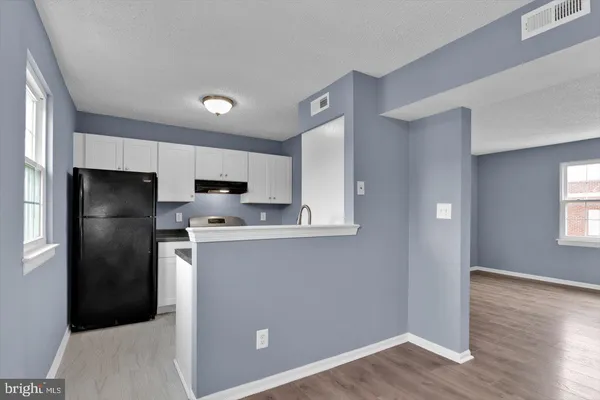 a kitchen with stainless steel appliances a refrigerator sink and microwave