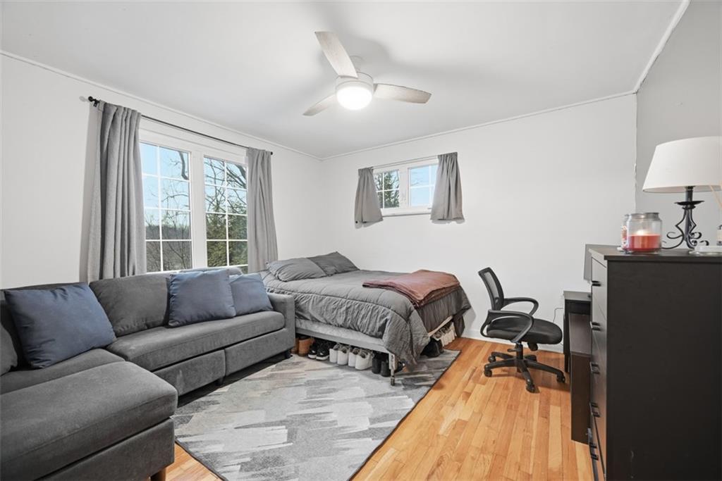 111 Rockingham Road Pittsburgh, PA 15238 - Photo 19 of 38 a spacious bedroom with a bed and a couch