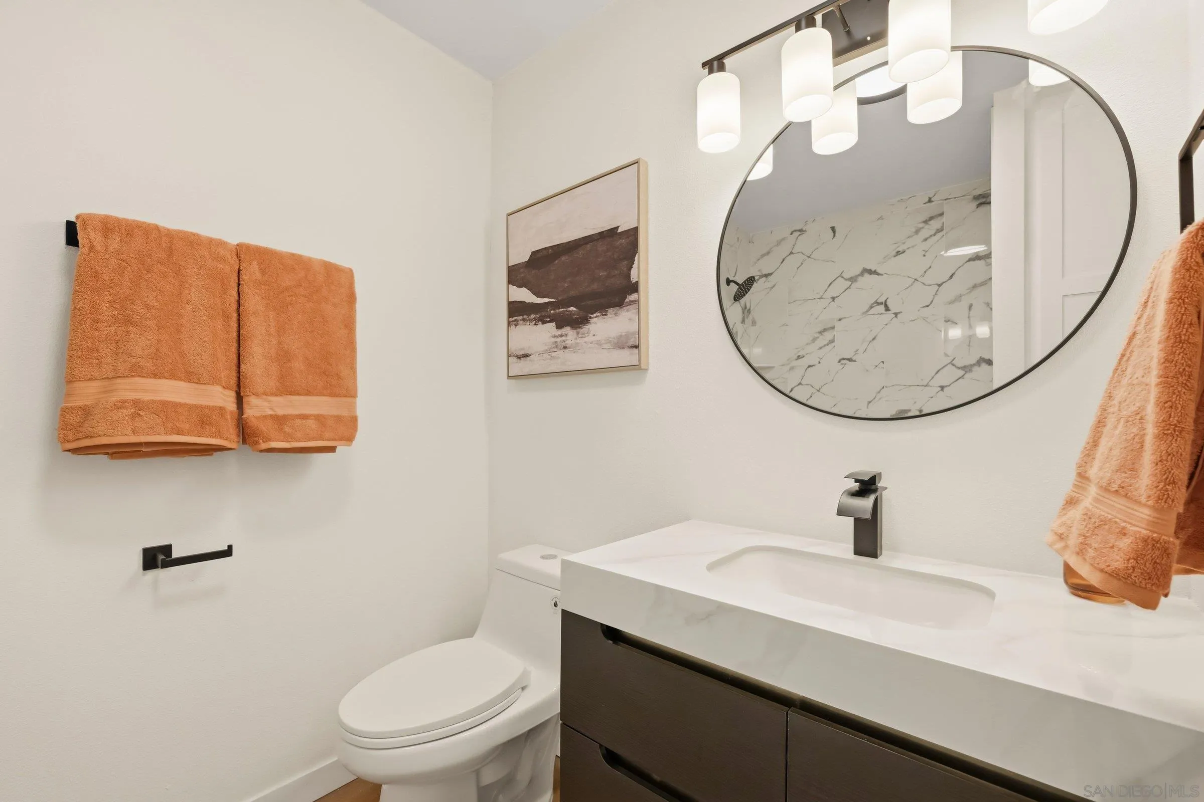 458 Ridgeway Court Spring Valley, CA 91977 - Photo 18 of 26 a bathroom with a toilet a sink and mirror