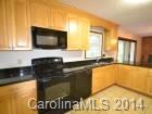 4438 Flowes Store Road Concord, NC 28025 - Photo 8 of 15 a view of a kitchen with a sink and a microwave